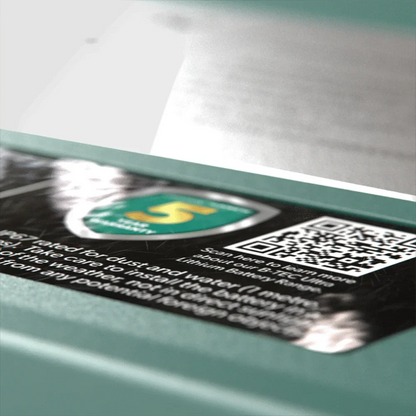 Close-up of a 12V lithium battery label with warranty badge and QR code, Off-Grid 12v accessory.