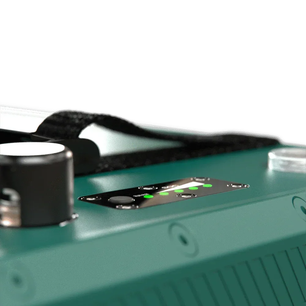 Close-up of a green 12V lithium battery with LED indicator lights and a black carry strap