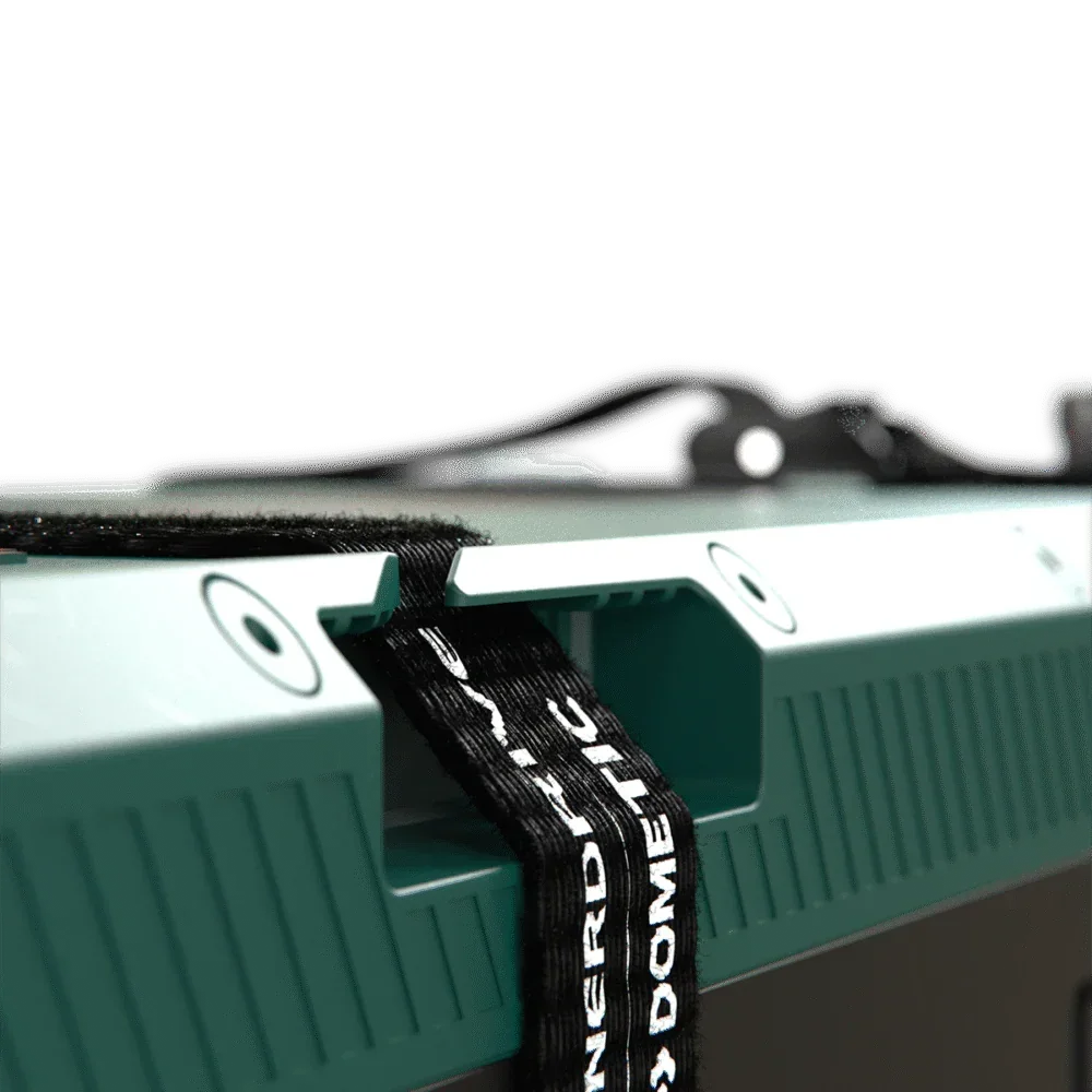 Close-up of a green 12V off-grid accessory with mounting strap, ideal for vehicle upgrades.