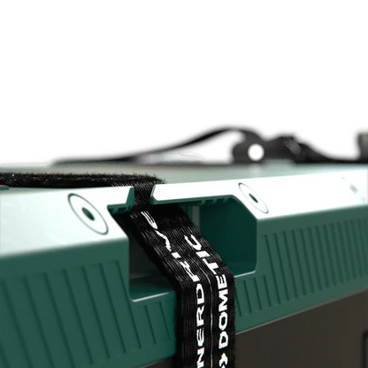 Close-up of a green 12V off-grid accessory with mounting strap, ideal for vehicle upgrades.