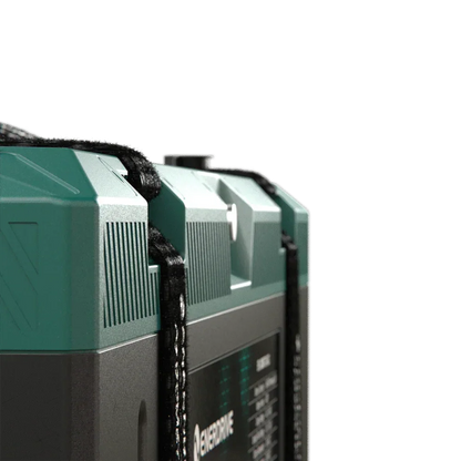 Close-up of a premium off-grid 12V battery with green casing and carrying strap.