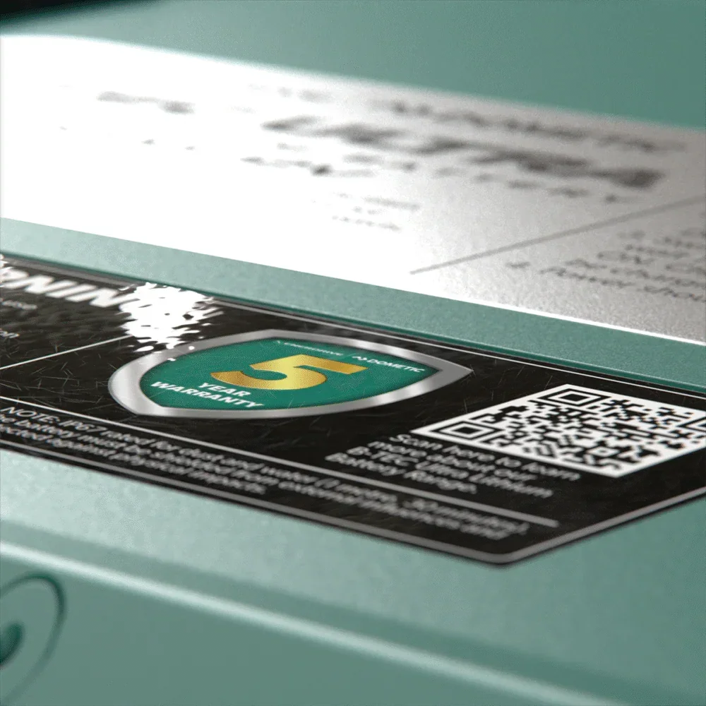 Close-up of a 12V off-grid accessory warranty label with QR code and 5-year guarantee.