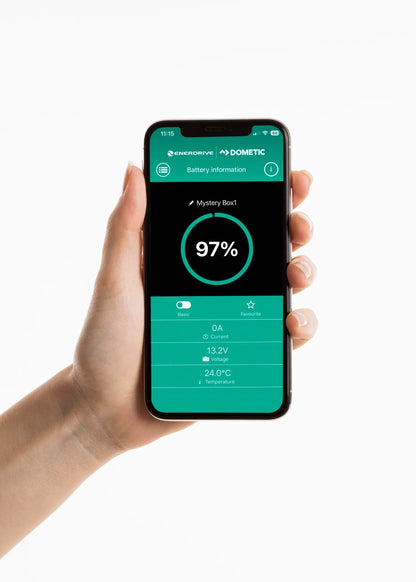 Hand holding phone displaying Enerdrive Dometic 12V battery monitoring app interface